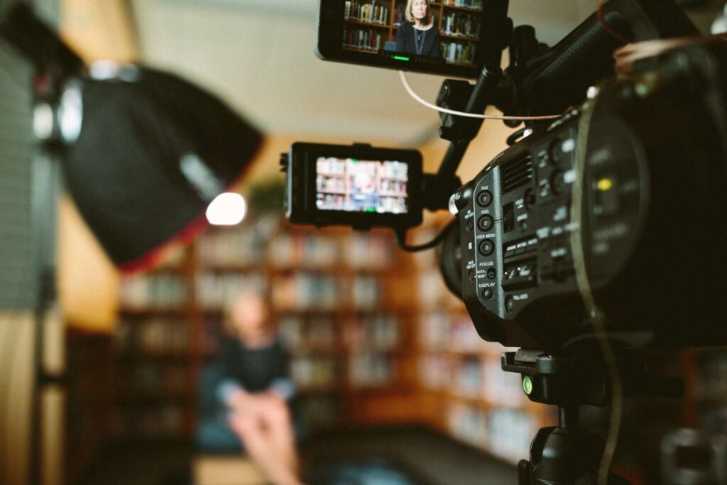 Camera and lighting setup interview a person.