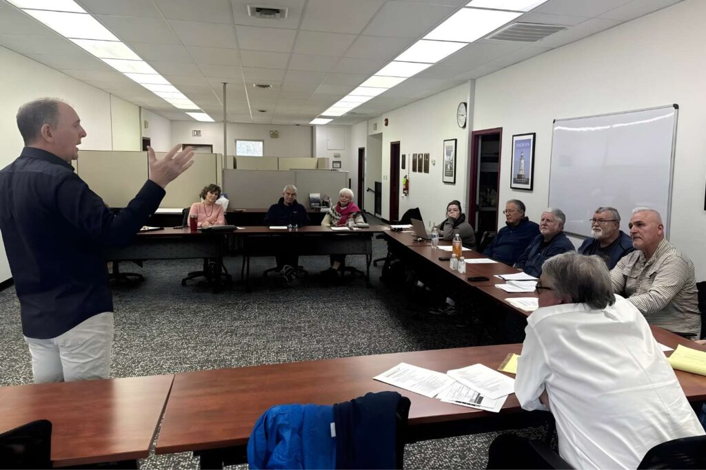 Facilitator standing before small audience.