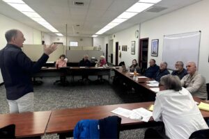 Facilitator standing before small audience.