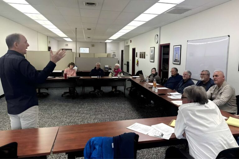Facilitator standing before small audience.