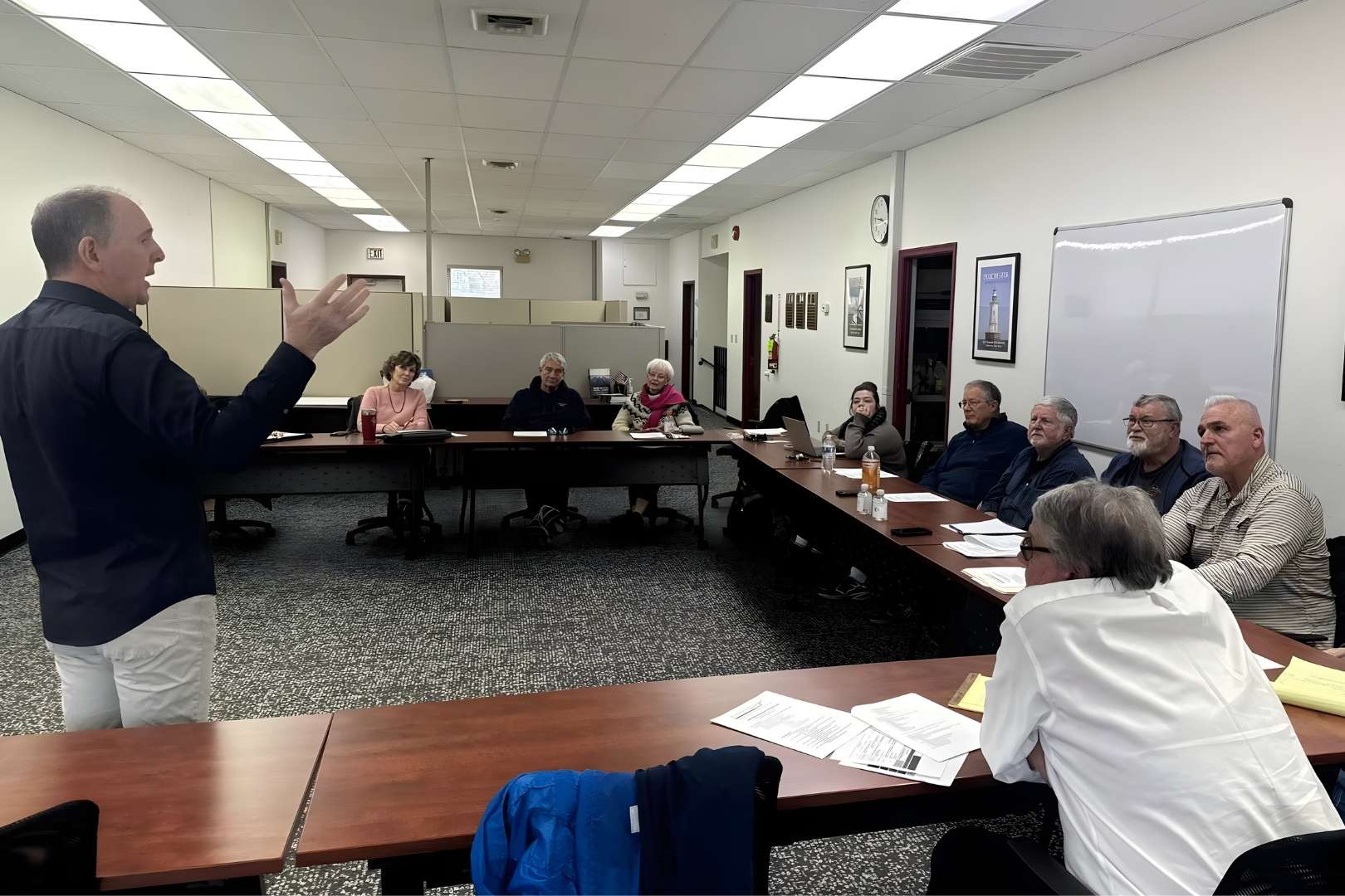 Facilitator standing before small audience.